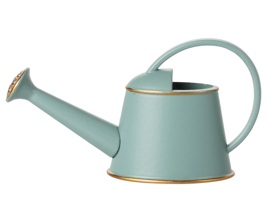Light blue watering can with gold accents on a white background