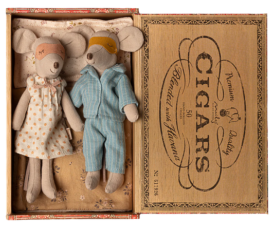 Two toy mice, a girl in a dress and a boy in overalls, inside an open cigar box with decorative text.