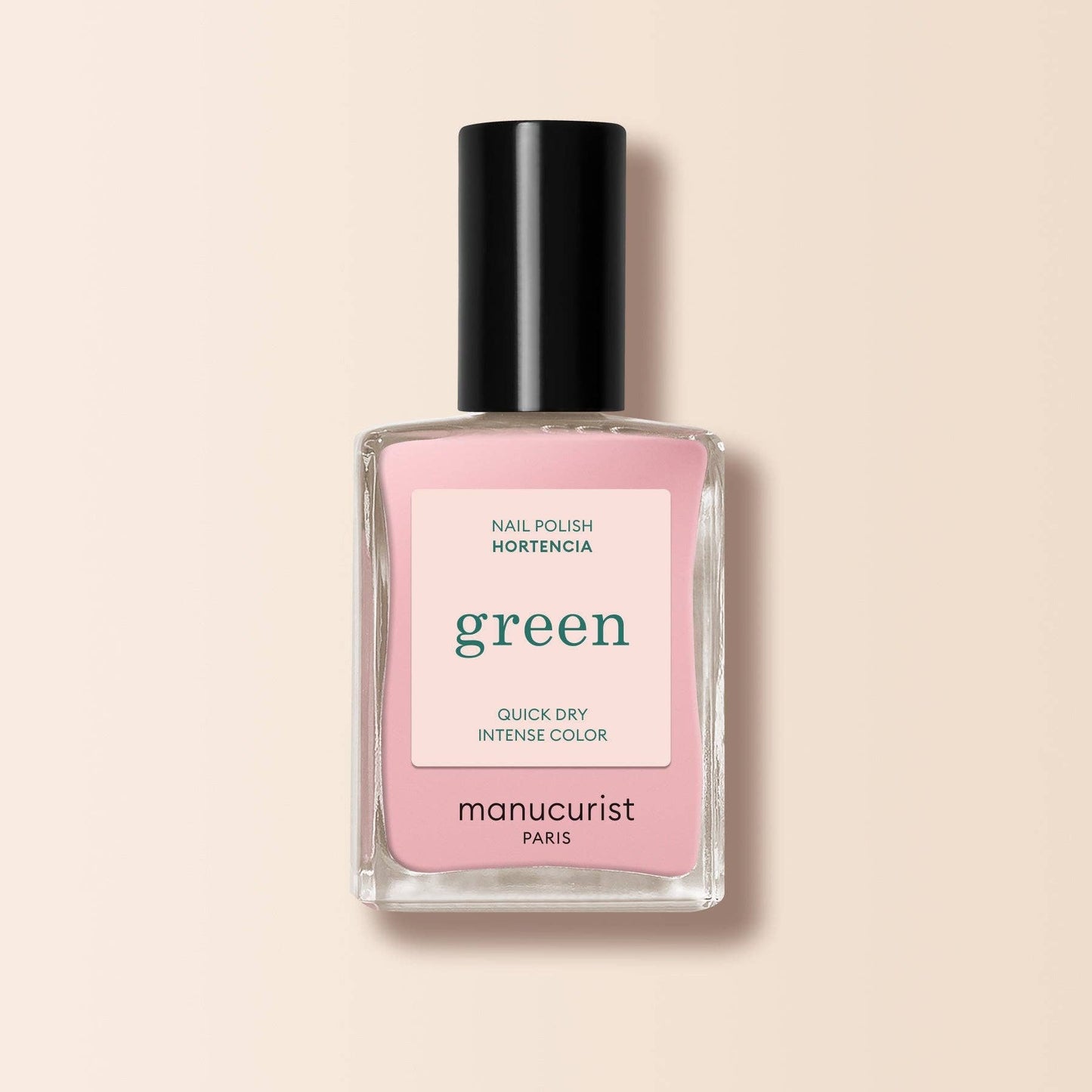 Pink nail polish bottle with black cap on a beige background
