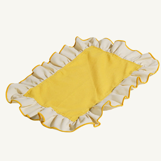 Yellow placemat with ruffled edge on a white background