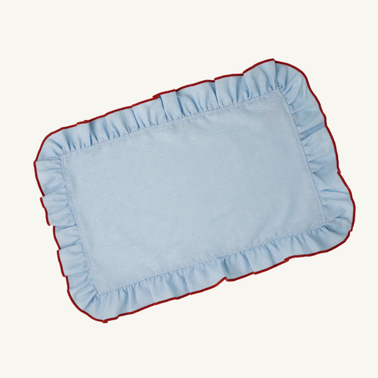 Rectangular blue placemats with red trim on a white background