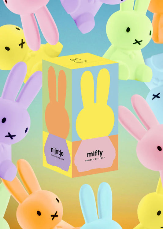 Colorful Miffy toy figures with a box in the center background