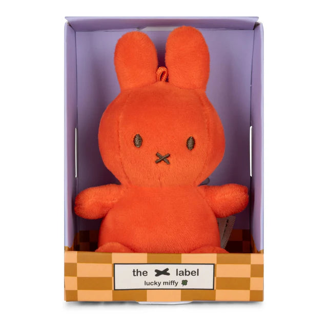 Orange plush toy in a checkered box with 'the label' branding