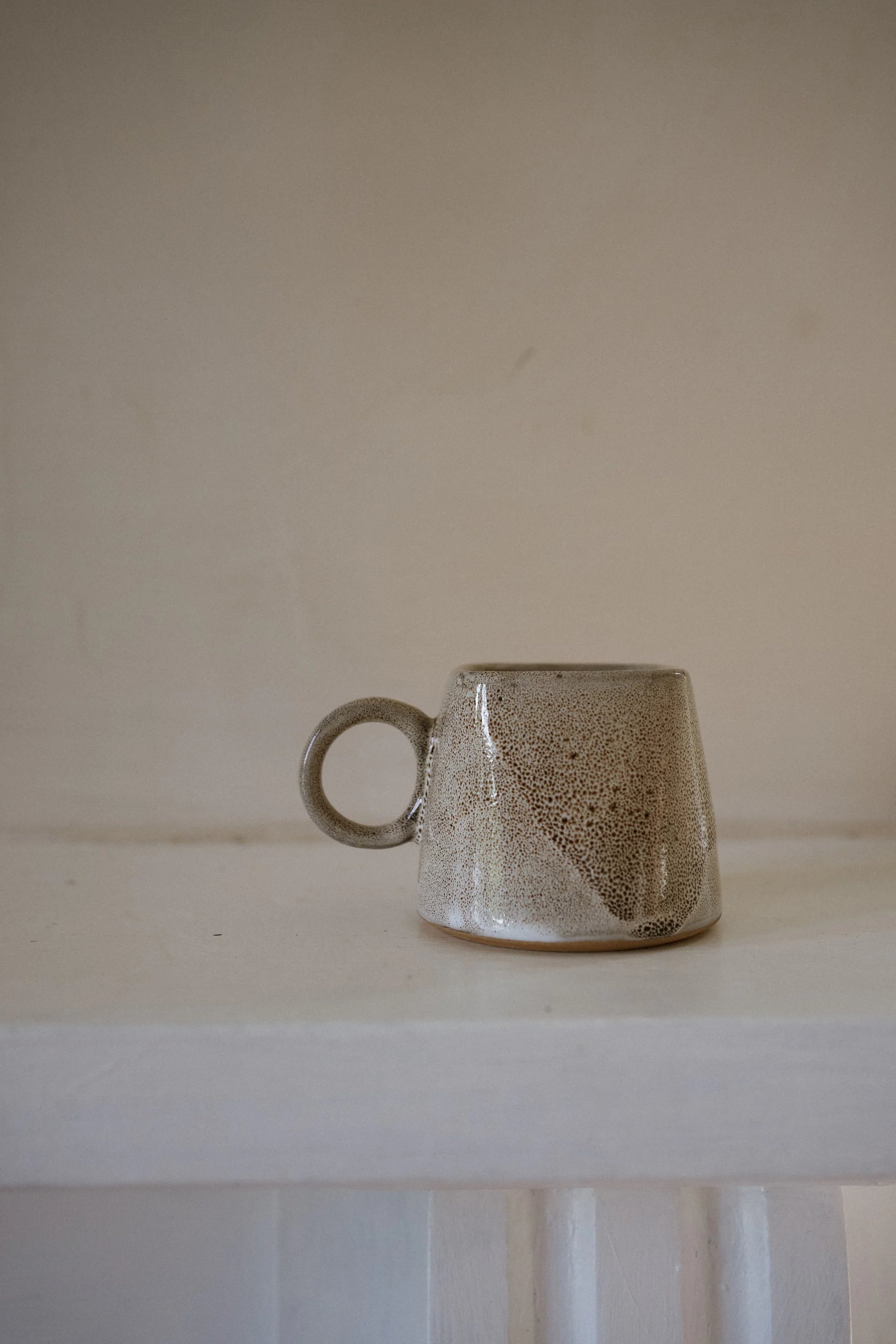 Morgan Wright Kaapi Cup in Tawny colourway on a beige background