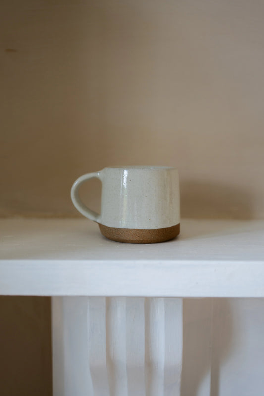 Morgan Wright Koko Mug in Milk White colour on a beige background 
