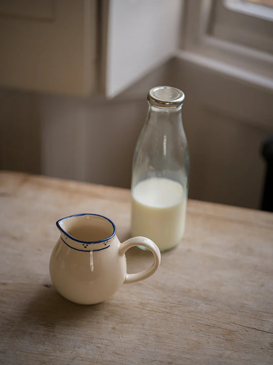 Morgan Wright The Breakfast Collection Milk Jug Blue in cream colours ith blue detailing on a grey-ish background 