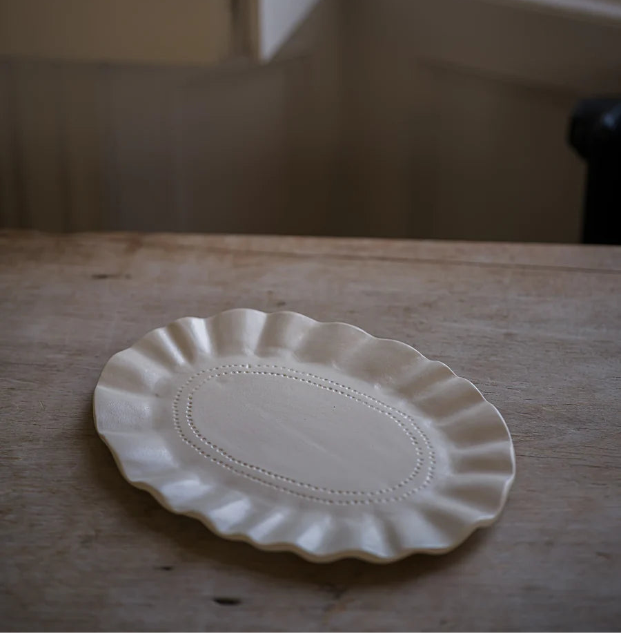 Morgan Wright The Studio Frilly Oval Platter on a beige kitchen background 