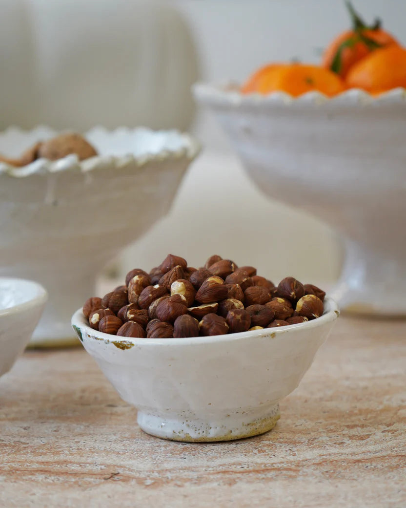 White cermic rustic glazed bowl on a beige/white background 