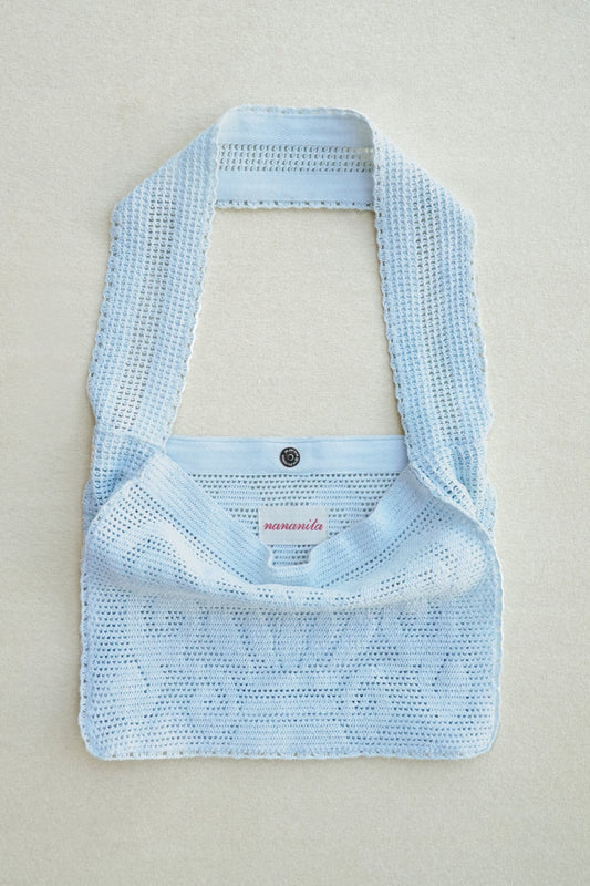 NANANITA Fountain Crochet Bag in light blue colour on a beige background 