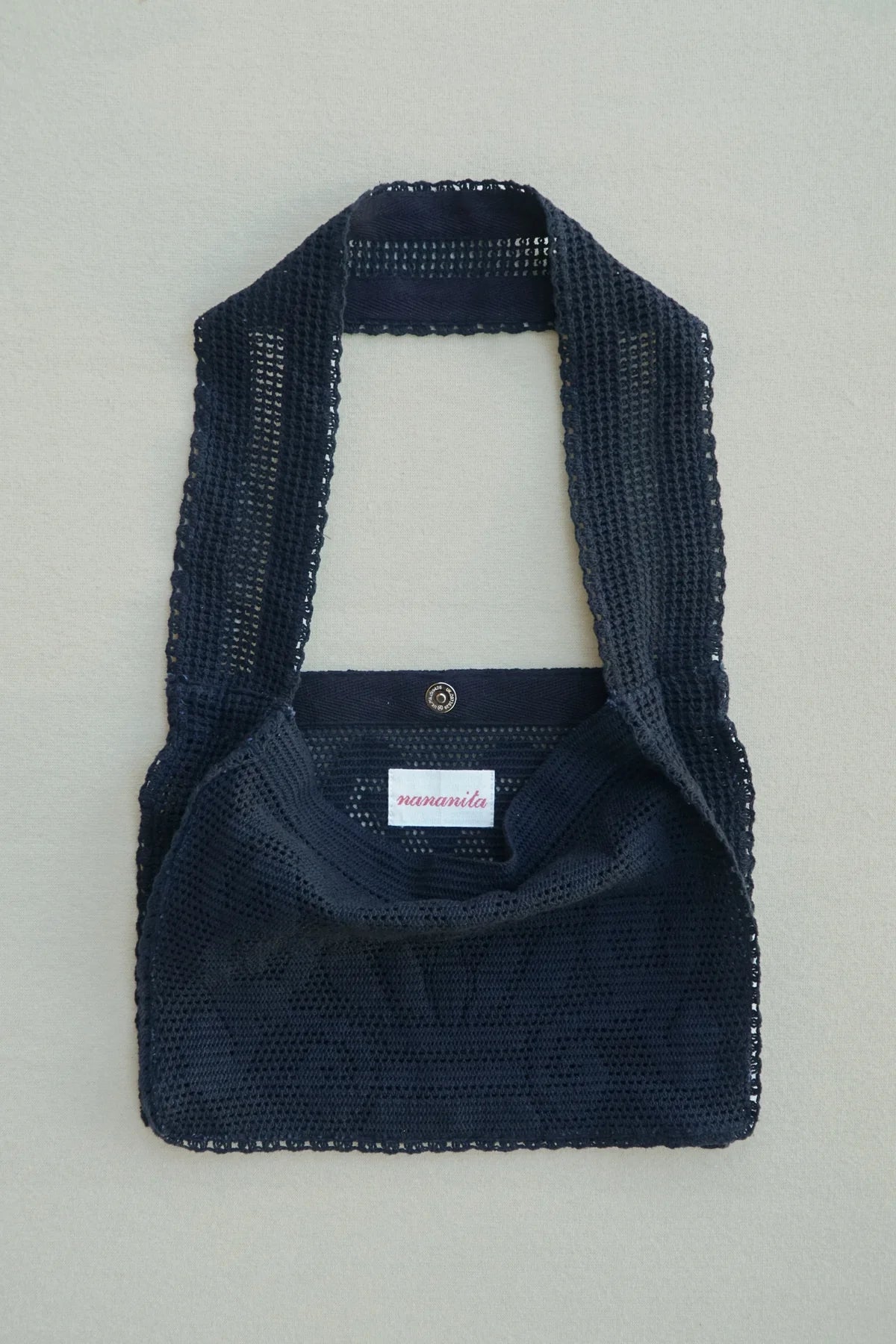 NANANITA Fountain Crochet Bag in Black colour on a beige background 