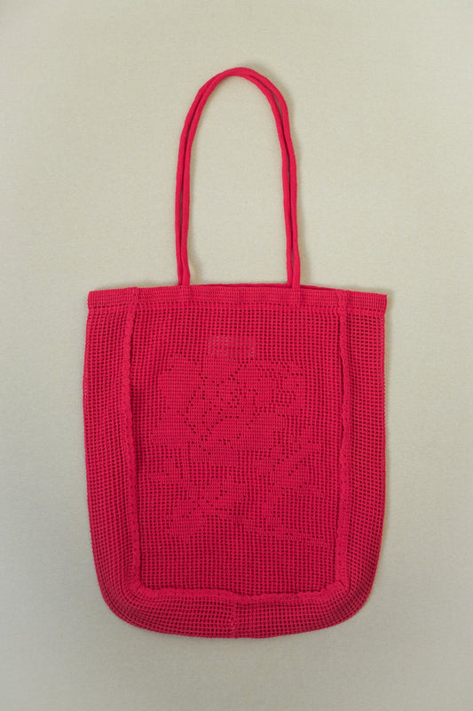 Red woven handbag on a beige background