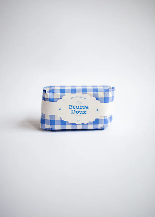 Candle shaped like butter in blue packaging