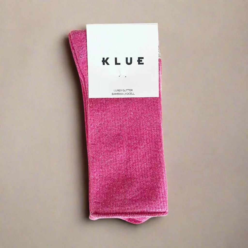 Pink sock with KLUE label on a beige background