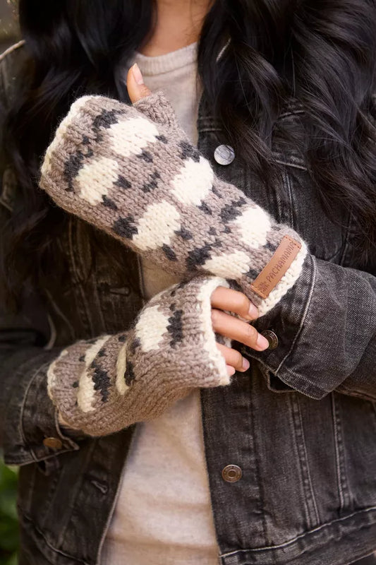 Person wearing patterned fingerless gloves with a denim jacket