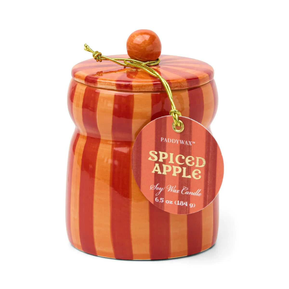 A Paddywax Spiced Apple scent wax melt candle in a decorative jar with orange and red vertical stripes, featuring a wooden lid knob and a hanging paper tag.