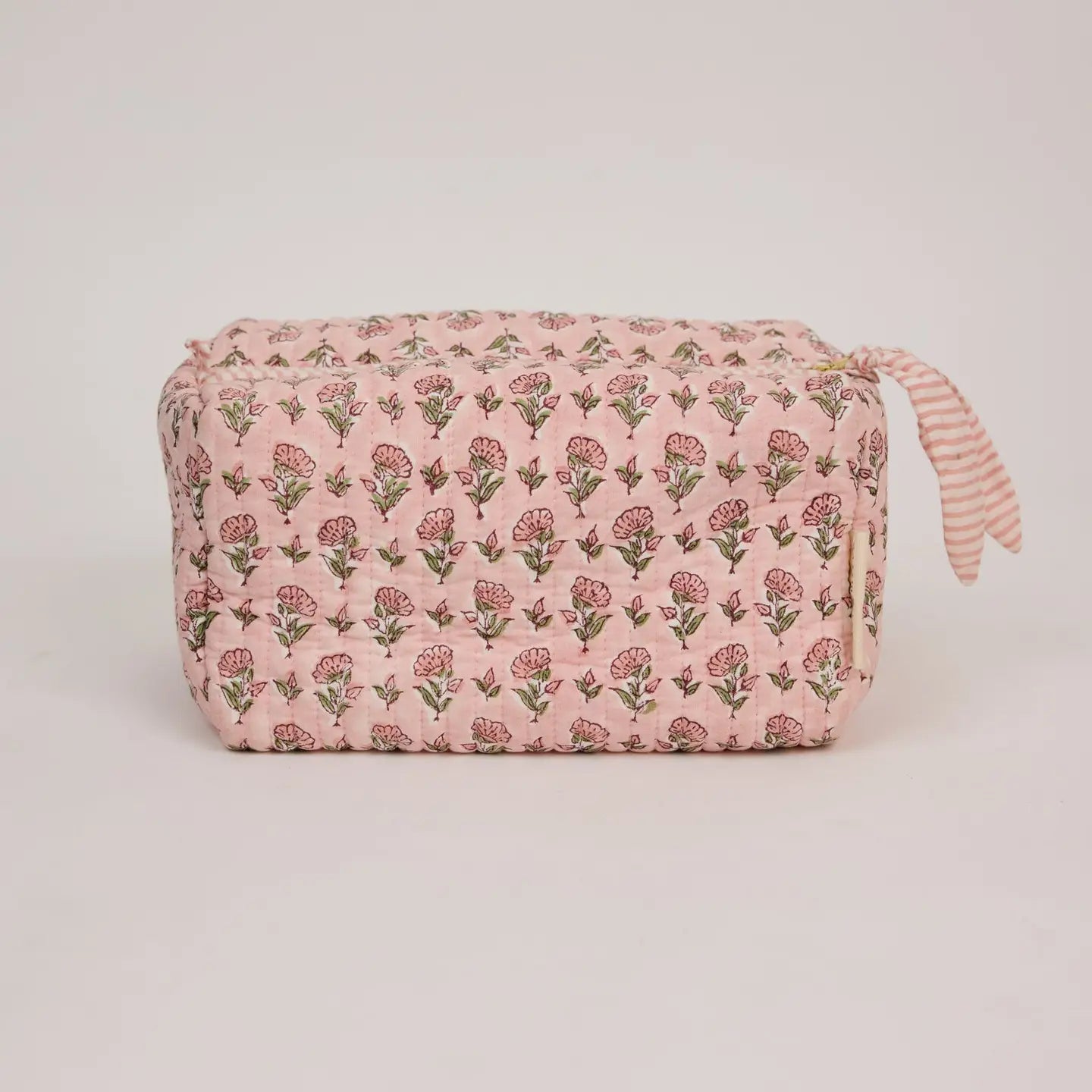 Floral-patterned pouch on a light gray background