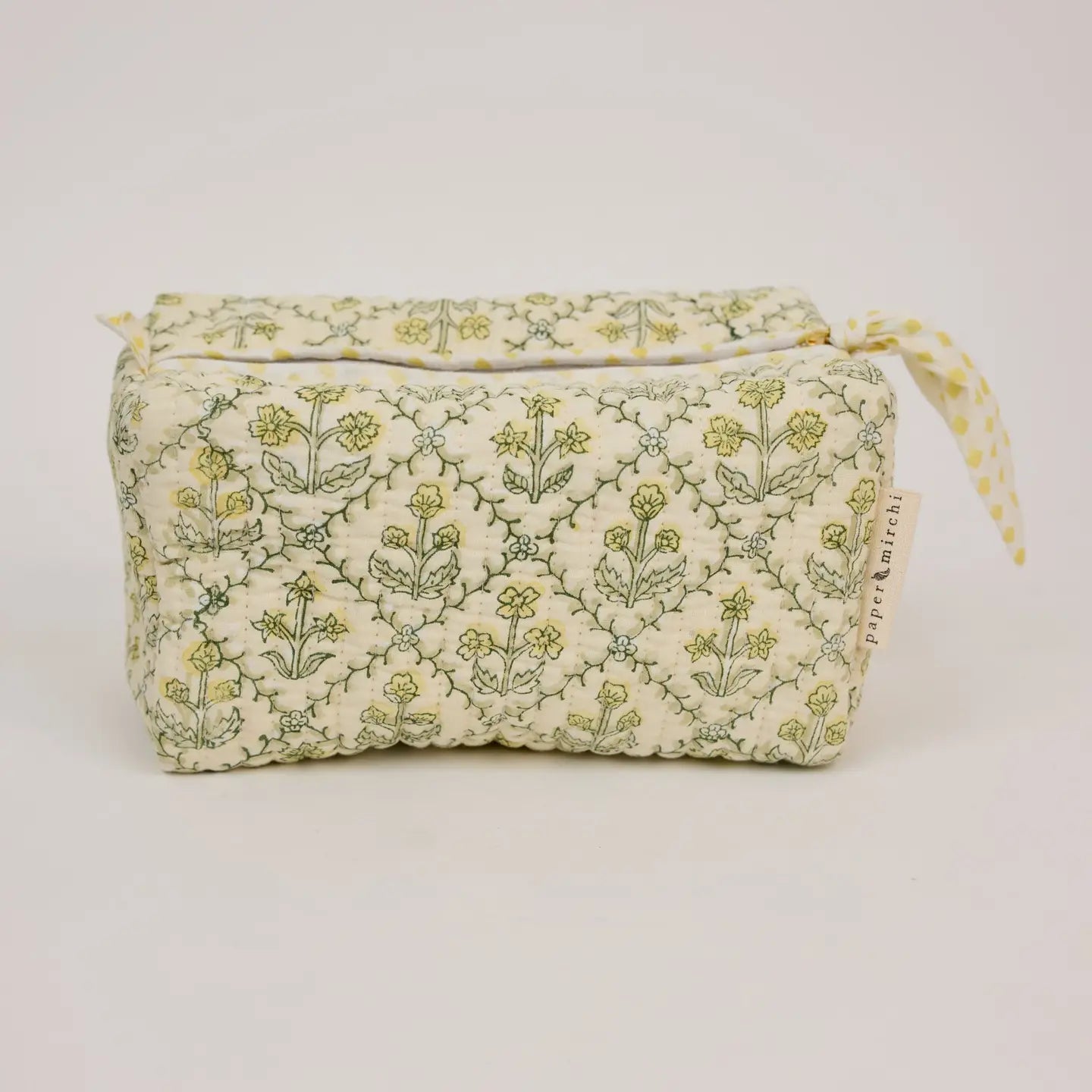 Floral-patterned fabric bag on a light gray background