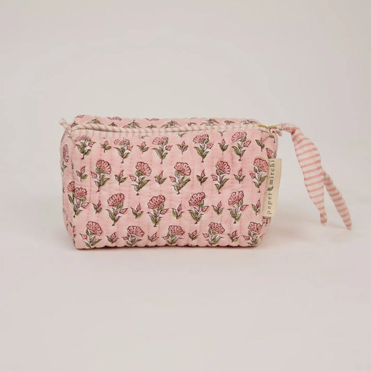 Pink floral pouch with striped handle on a light pink background