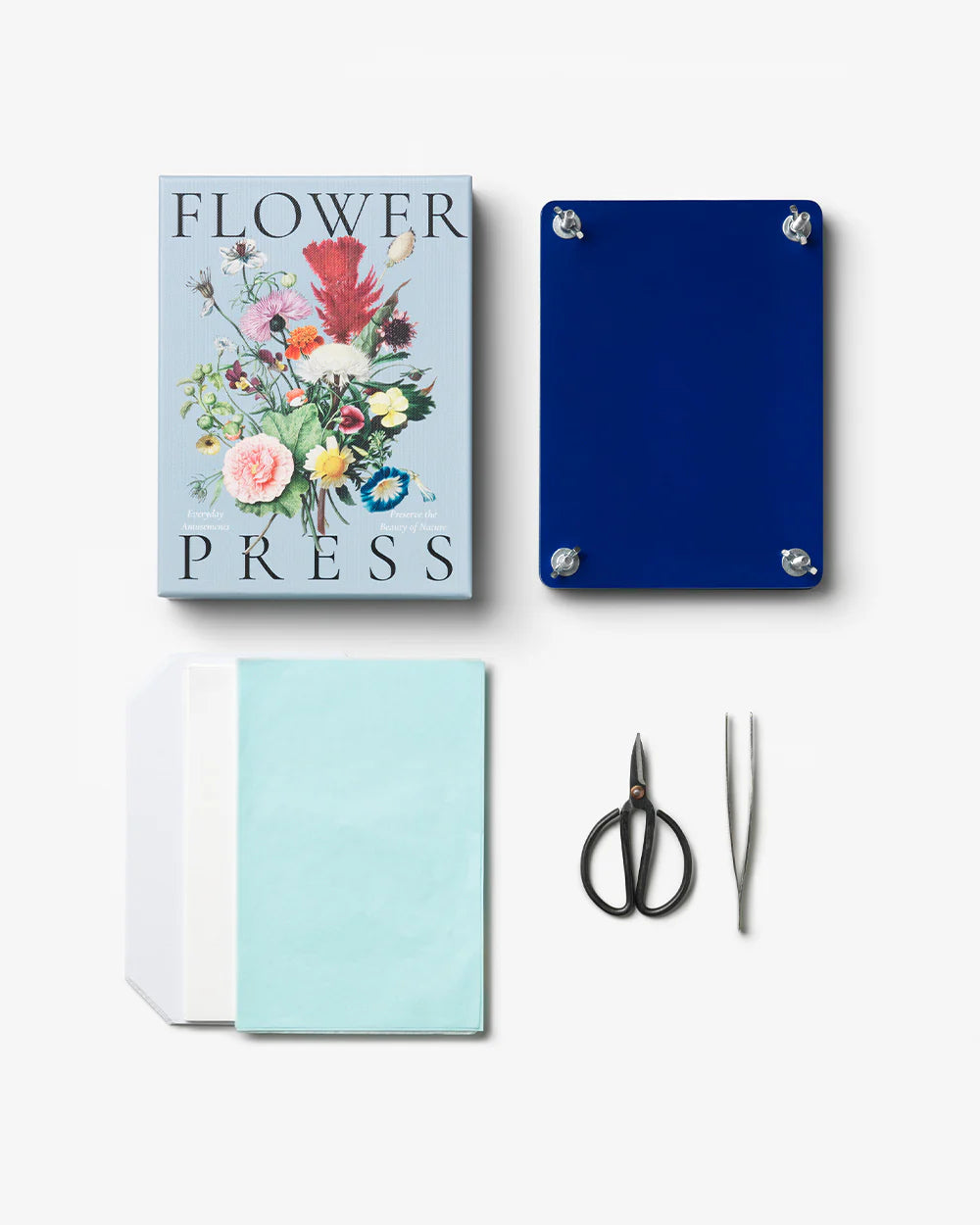 Flower press kit with a blue box, floral design, scissors, and tweezers on a white background