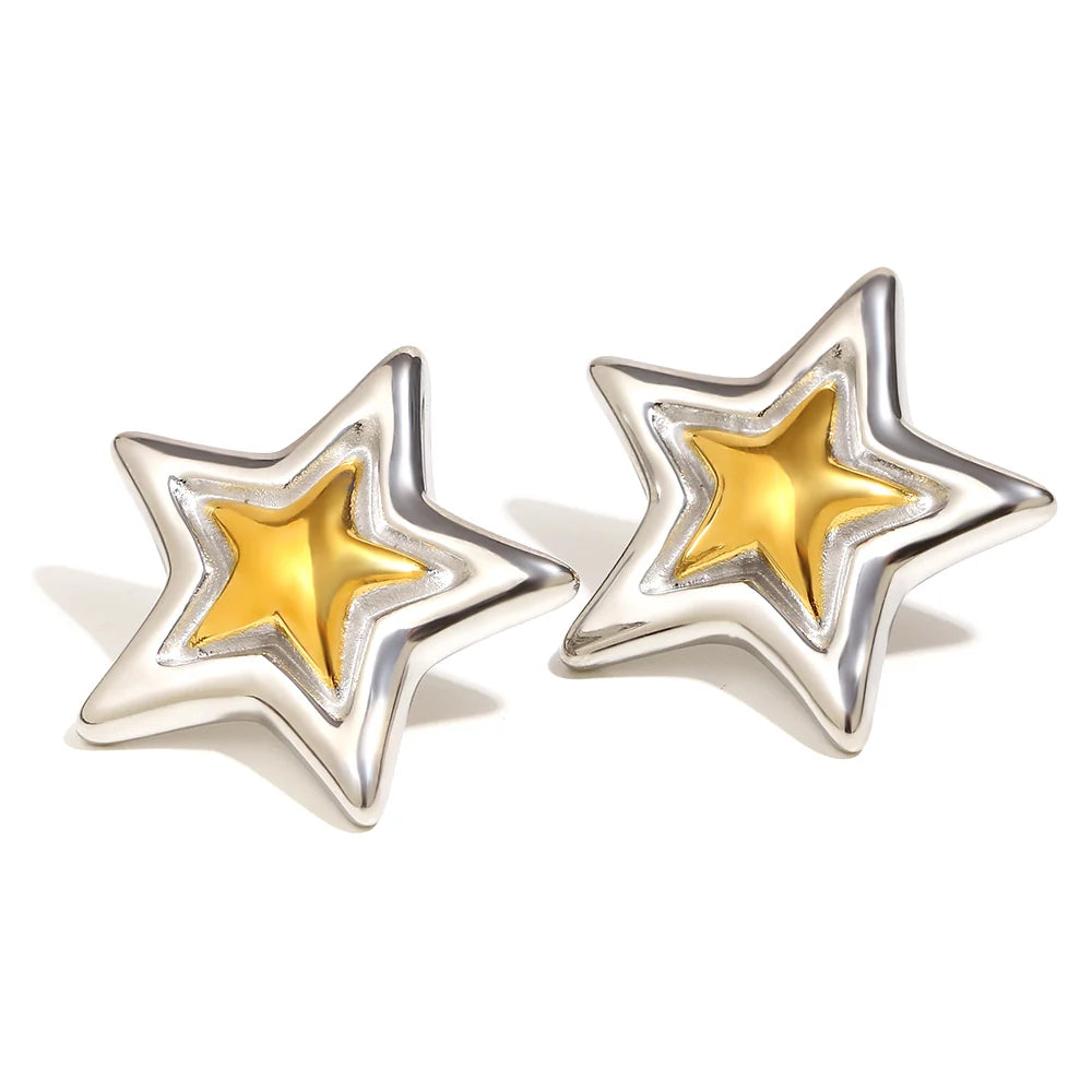 A pair of silver star-shaped stud earrings with a polished yellow gold center star, shown on a clean white background.