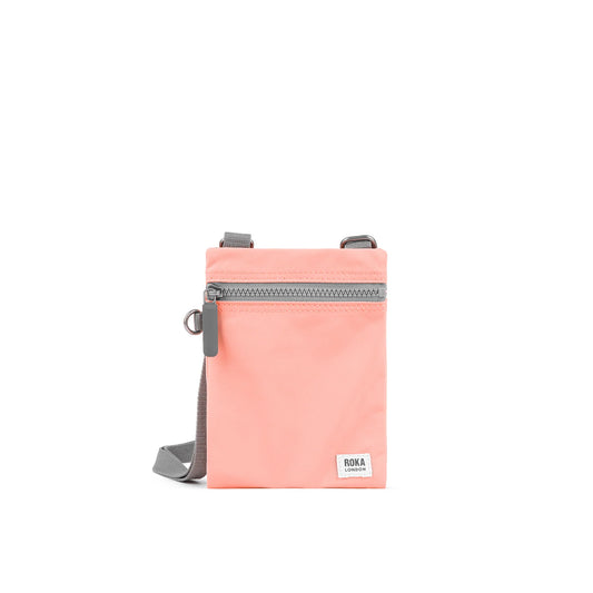 Roka Chelsea Recycled Nylon Bag in 'Punch' colour a peachy pastel pink