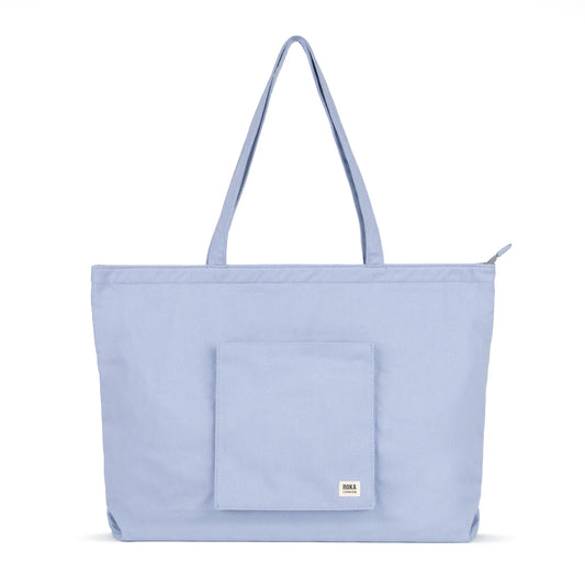 Light blue tote bag with a pocket on a white background