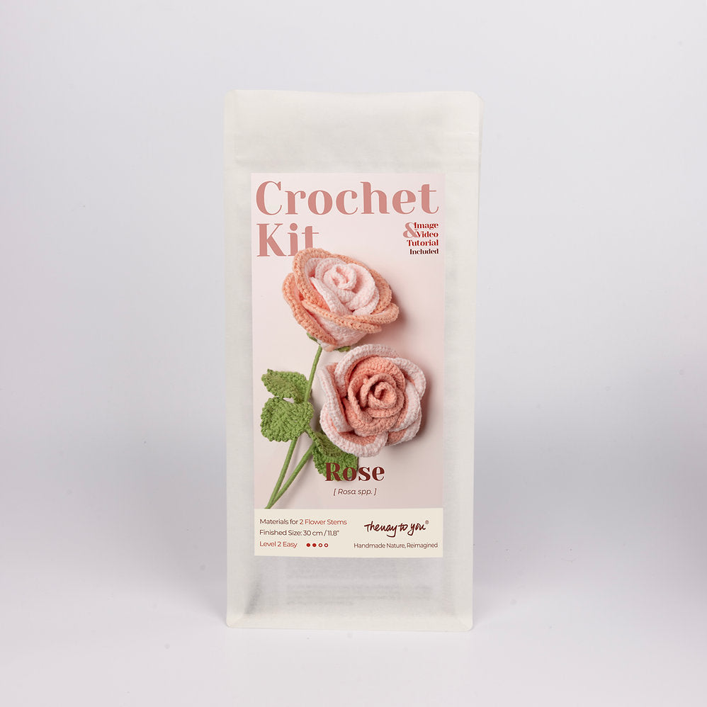 Crochet kit packaging with two pink roses on a white background