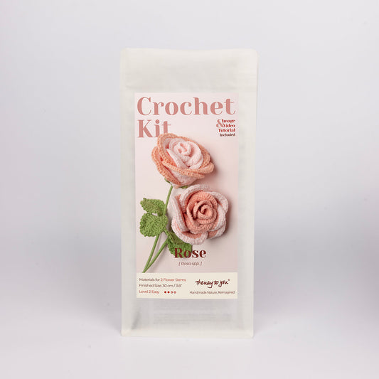 Crochet kit packaging with two pink roses on a white background