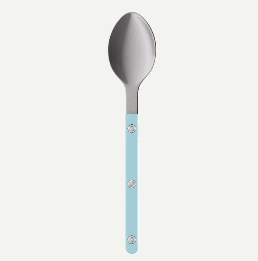 A stainless steel spoon with a light blue handle featuring three silver rivets, shown vertically against a light gray background.