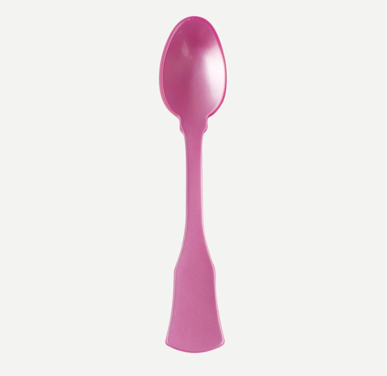A single pink plastic spoon with a decorative handle, shown vertically against a plain light gray background.