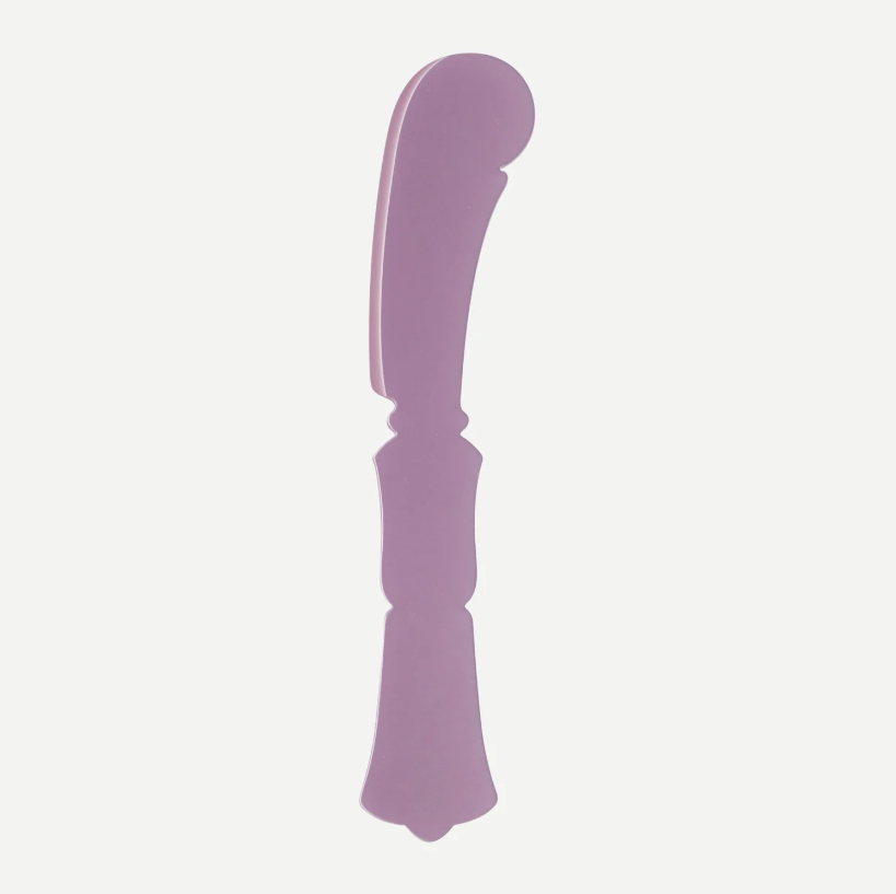 A single lavender purple plastic or silicone kitchen utensil, likely a scraper or turner, shown vertically against a plain off-white background.