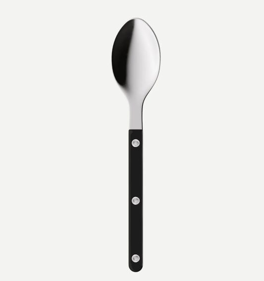 A modern stainless steel spoon with a black handle featuring three silver rivets, shown vertically against a light gray background.
