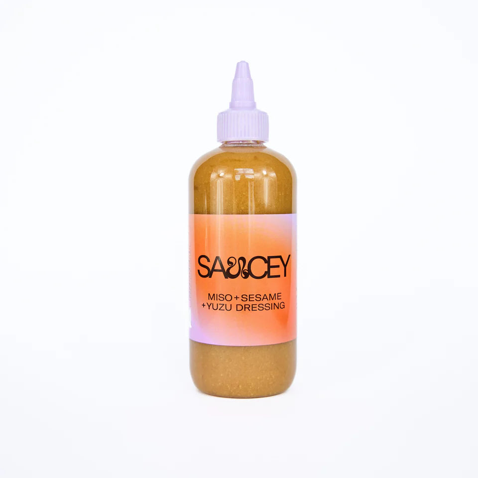 Bottle of miso, seasame and yuzu dressing sauce on a white background