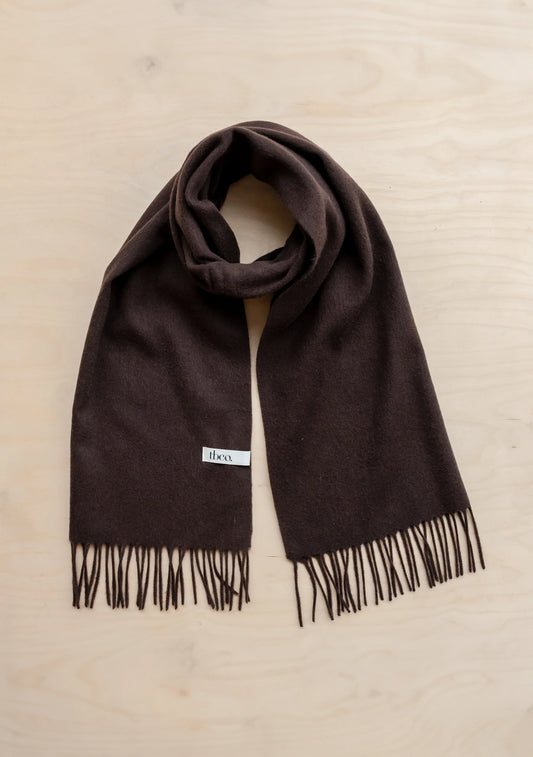 Brown scarf with fringes on a beige background