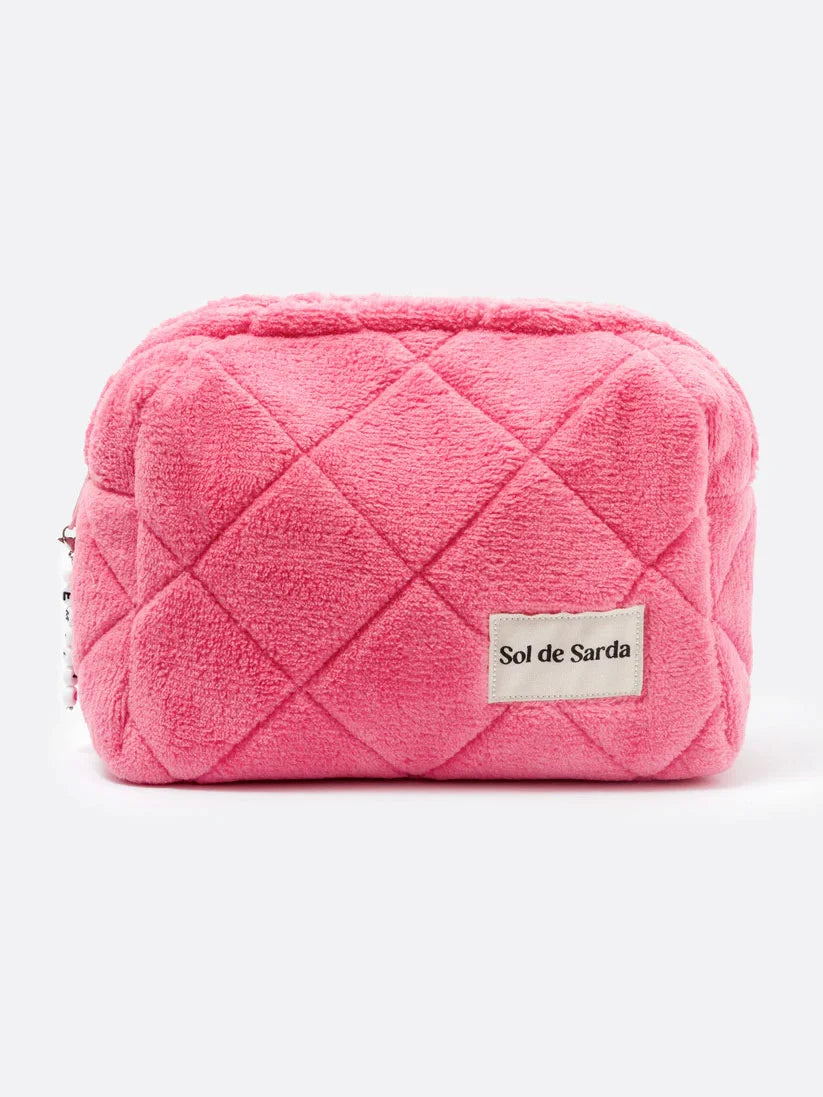 PINK TERRY MAKEUP POUCH ON A WHITE BACKGROUND 