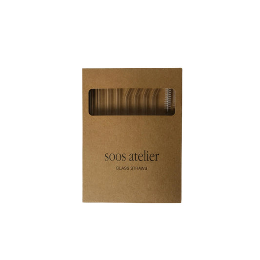 Kraft paper box with glass straws inside, branded 'soos atelier'.