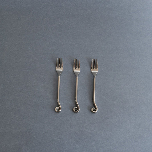 SOOS Atelier Mira Cake Fork set of 3 on a blue background 
