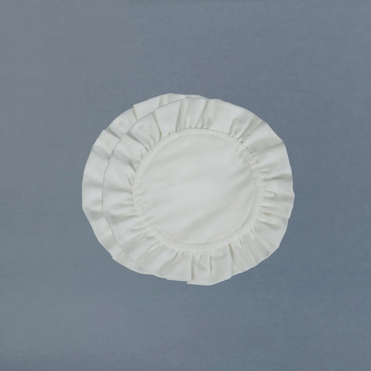 White round fabric coasters on a gray background