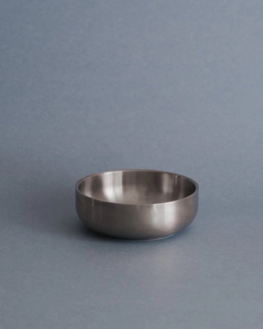 Metallic bowl on a gray background