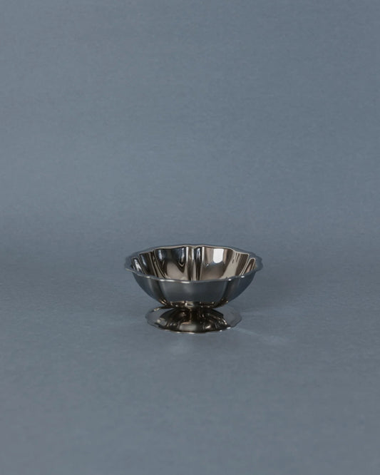Small metallic bowl on a gray background