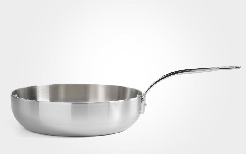 Stainless steel frying pan on a white background