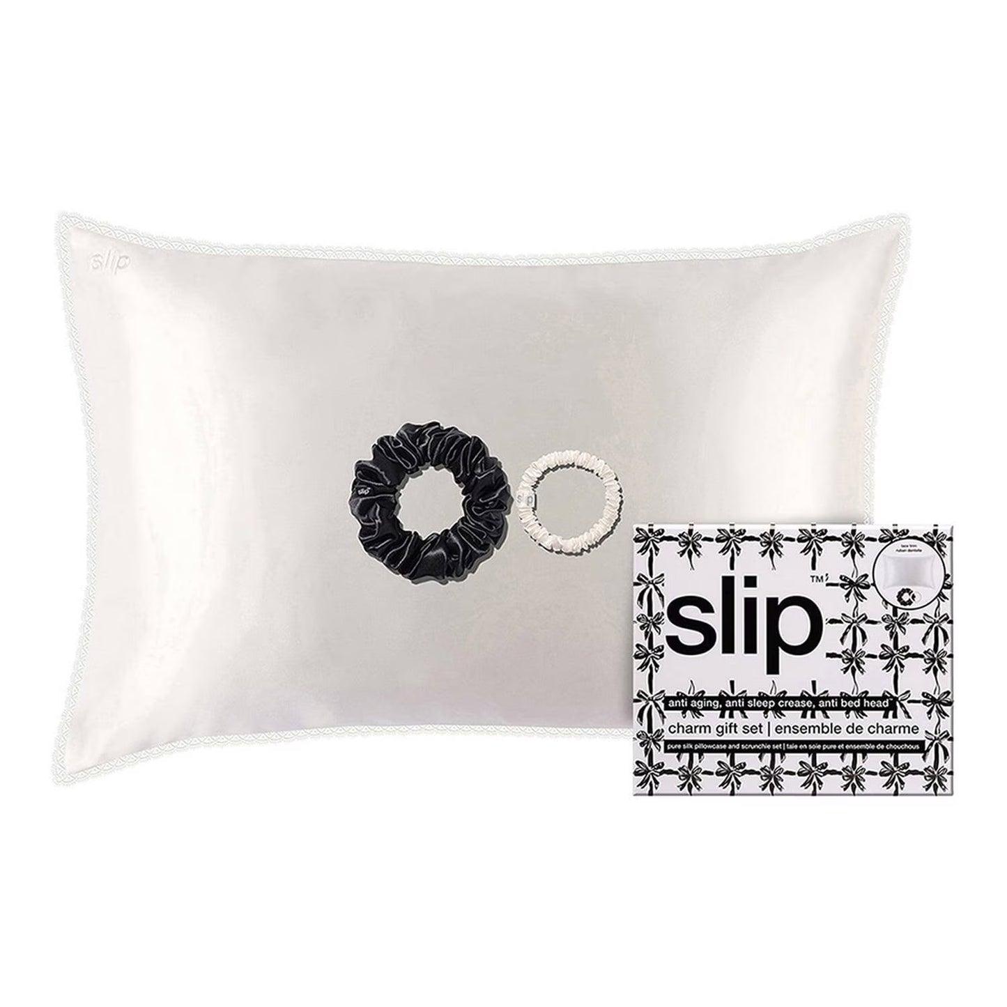 Silk pillowcase with black scrunchie and white white scrunchies on a white background, featuring the 'slip' brand.