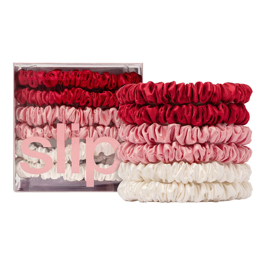 Set of red, pink, and white scrunchies with 'SLIP' packaging on a white background