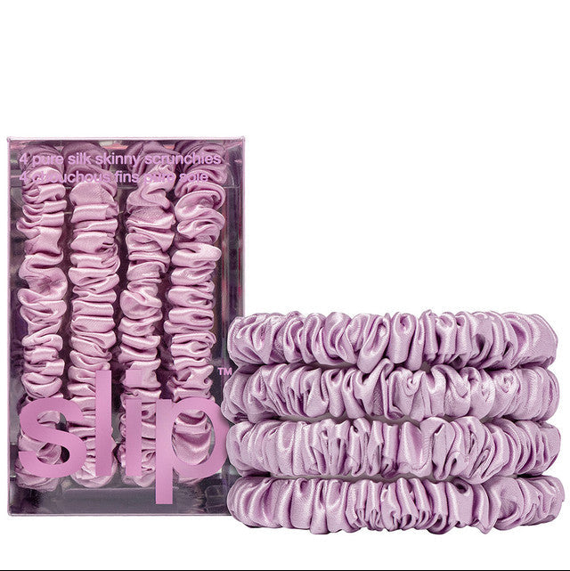 Set of purple hair scrunchies with packaging on a white background