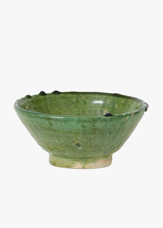 Green ceramic bowl on a white background