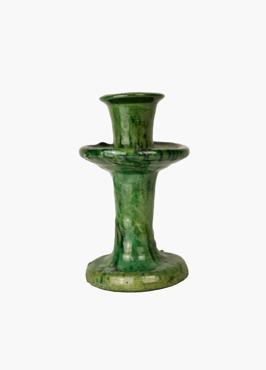 Green ceramic candle holder on a white background