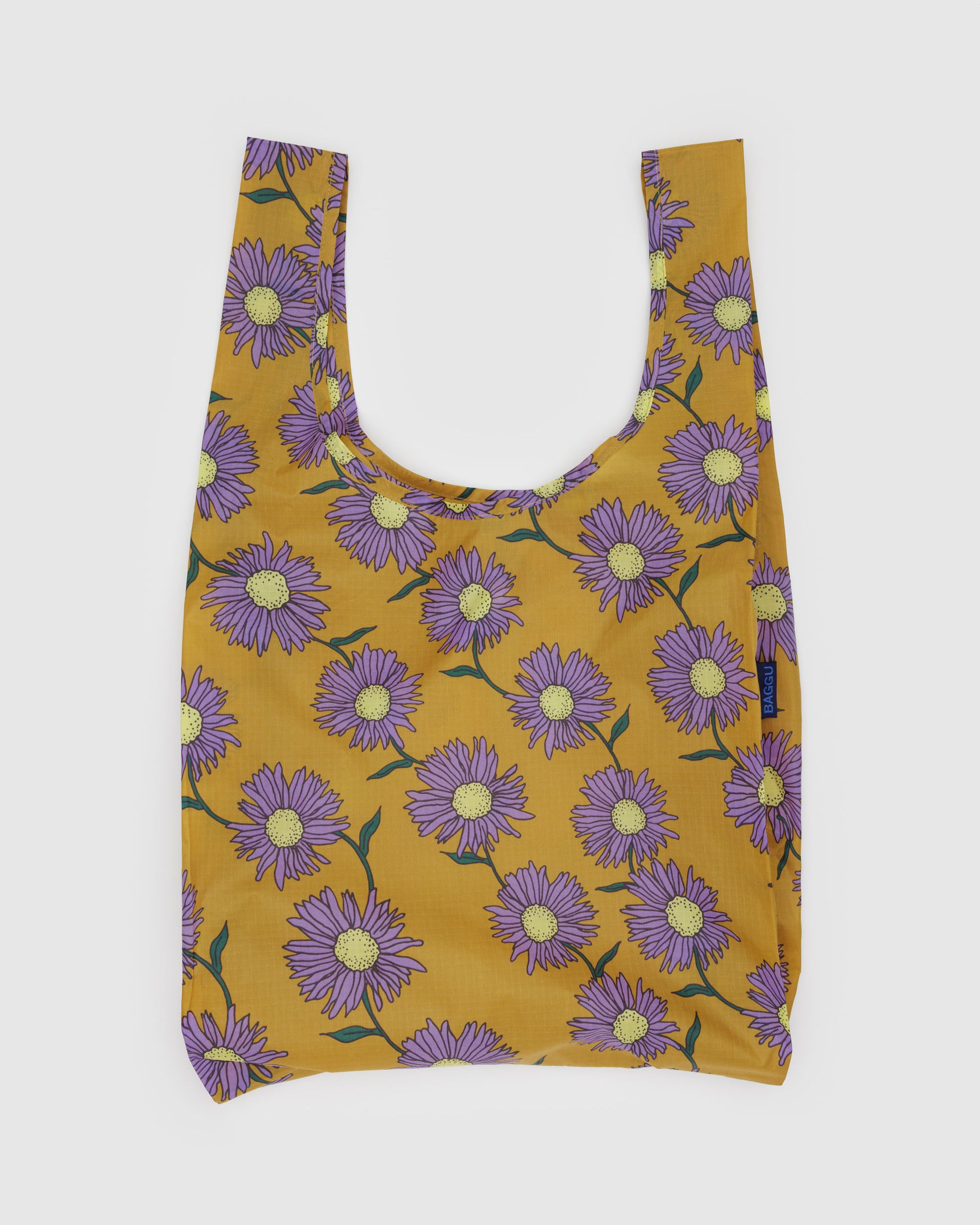 Reusable bag with purple floral pattern on a mustard yellow background