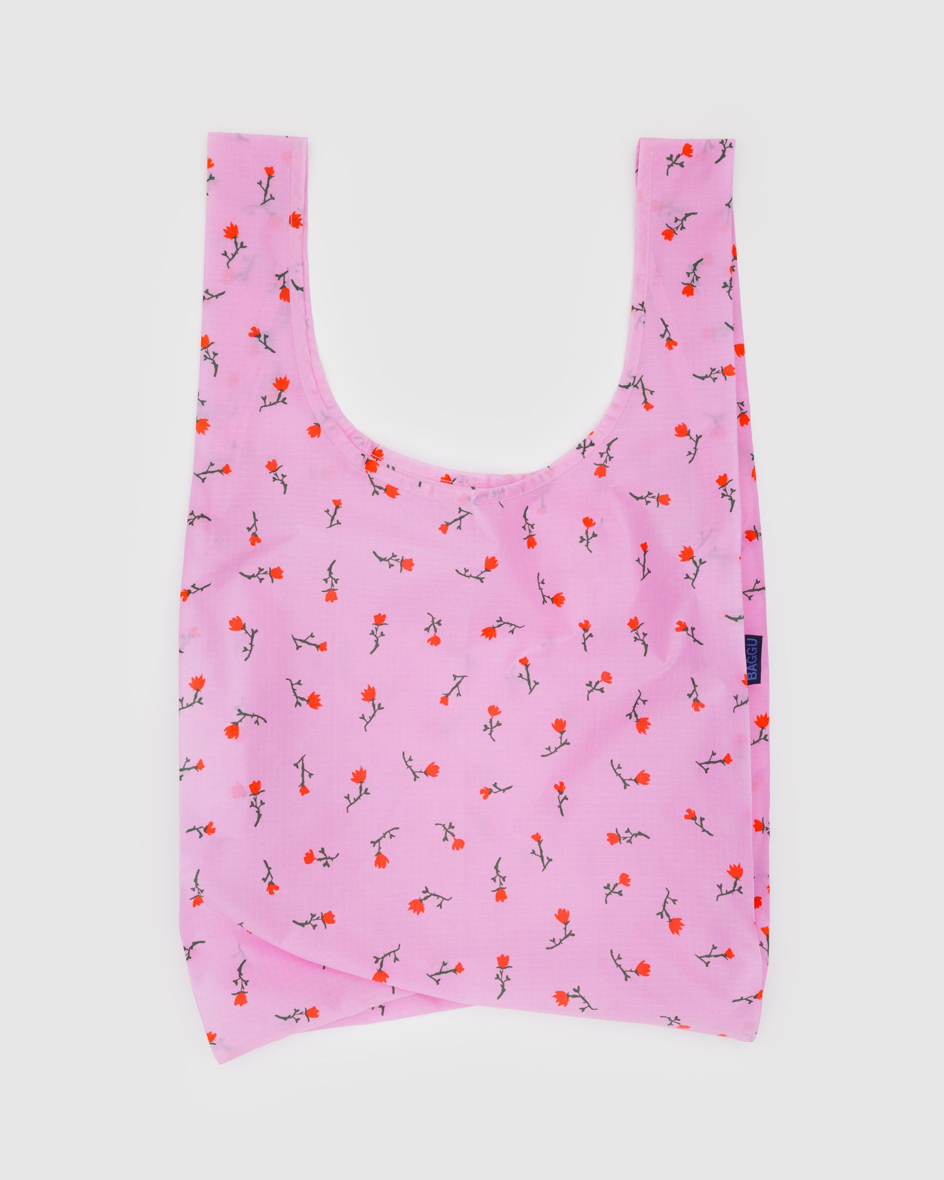 Pink reusable bag with floral pattern on a white background