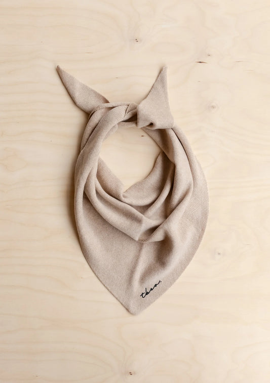 Beige scarf with a bow on a beige background