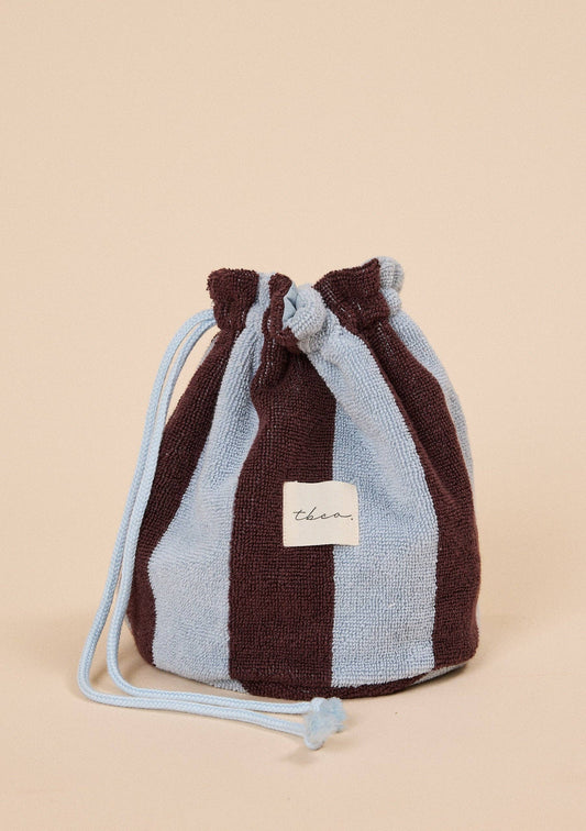 Drawstring bag with brown and blue striped pattern on a beige background